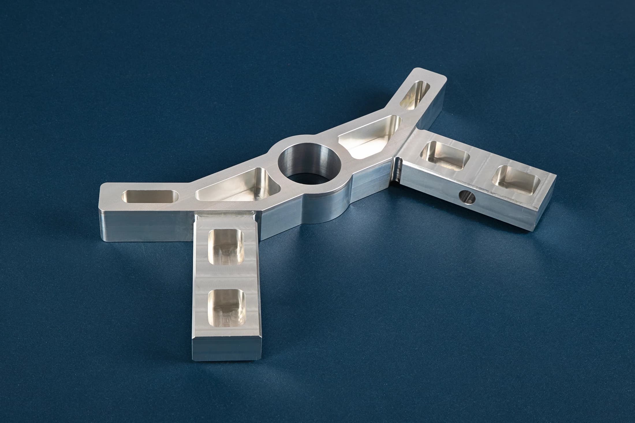 CNC Experts part with four arms, pockets and a central opening