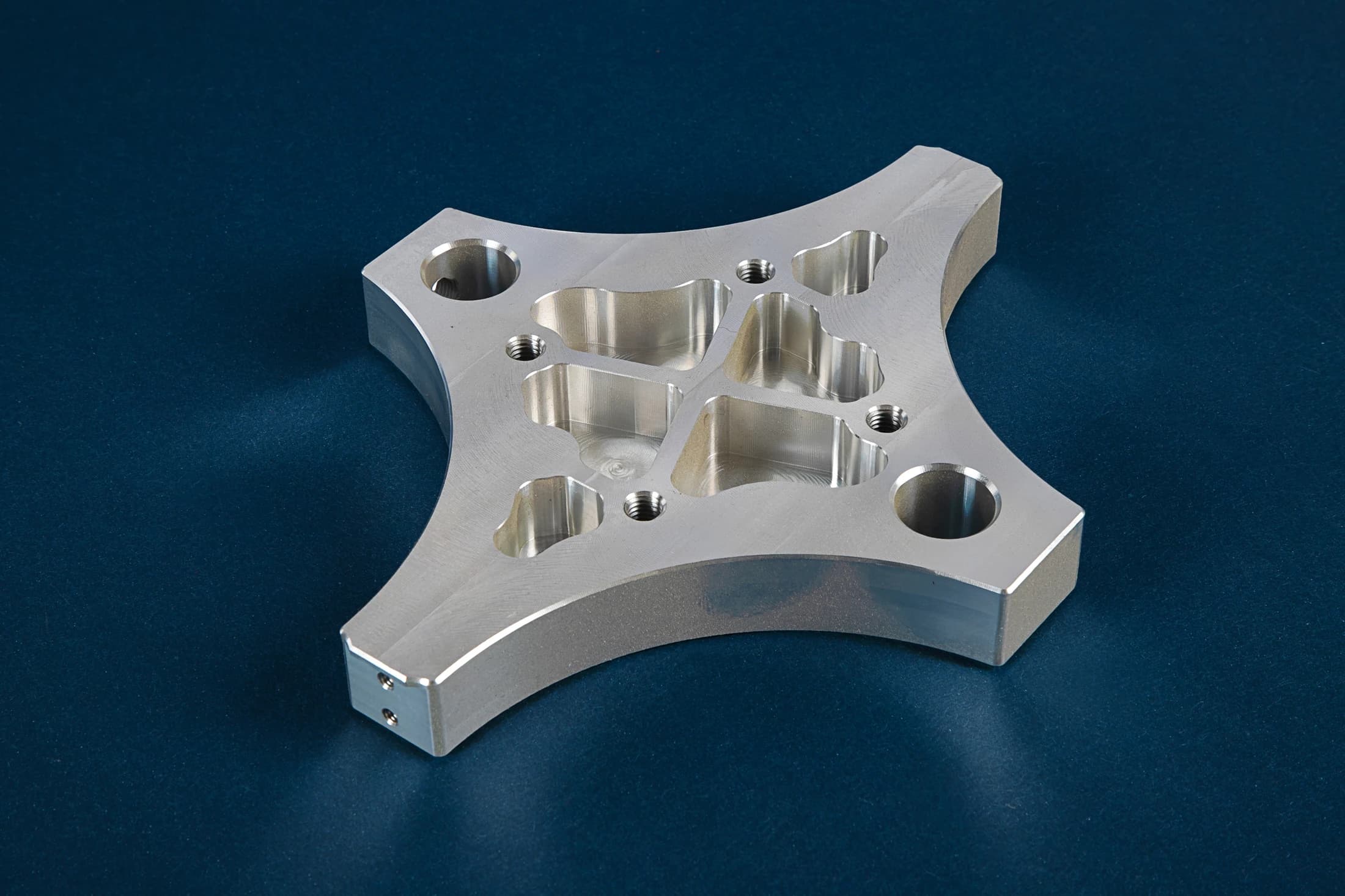 Contoured plate with holes on a dark blue background