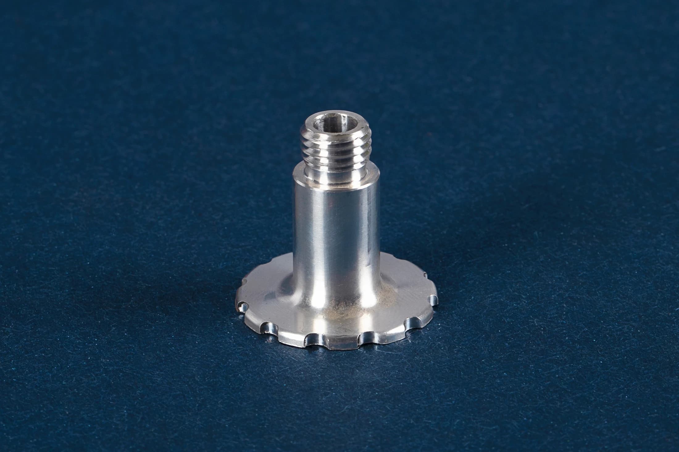 Threaded flange part on a dark blue background