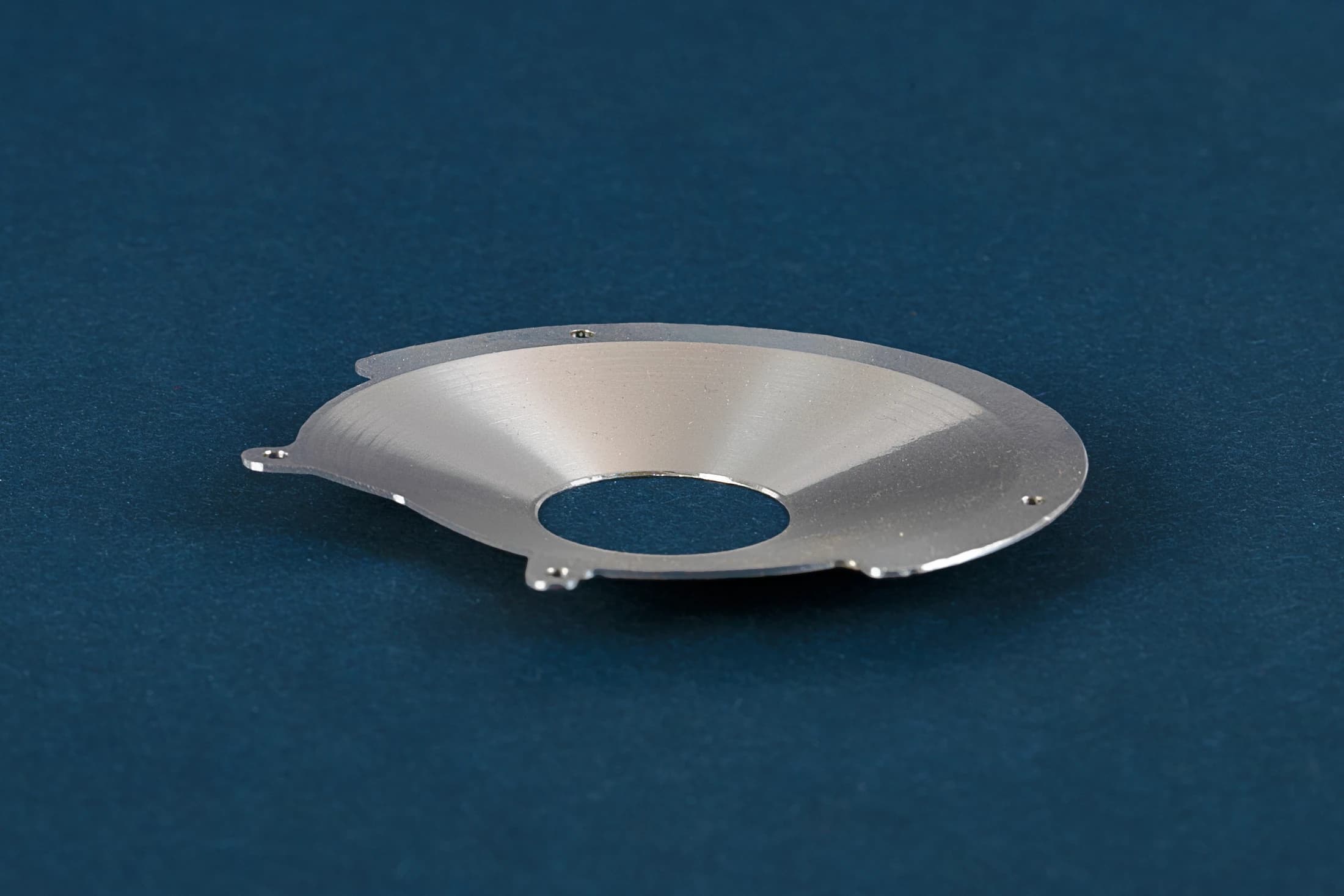 Disc-shaped part on a dark blue background