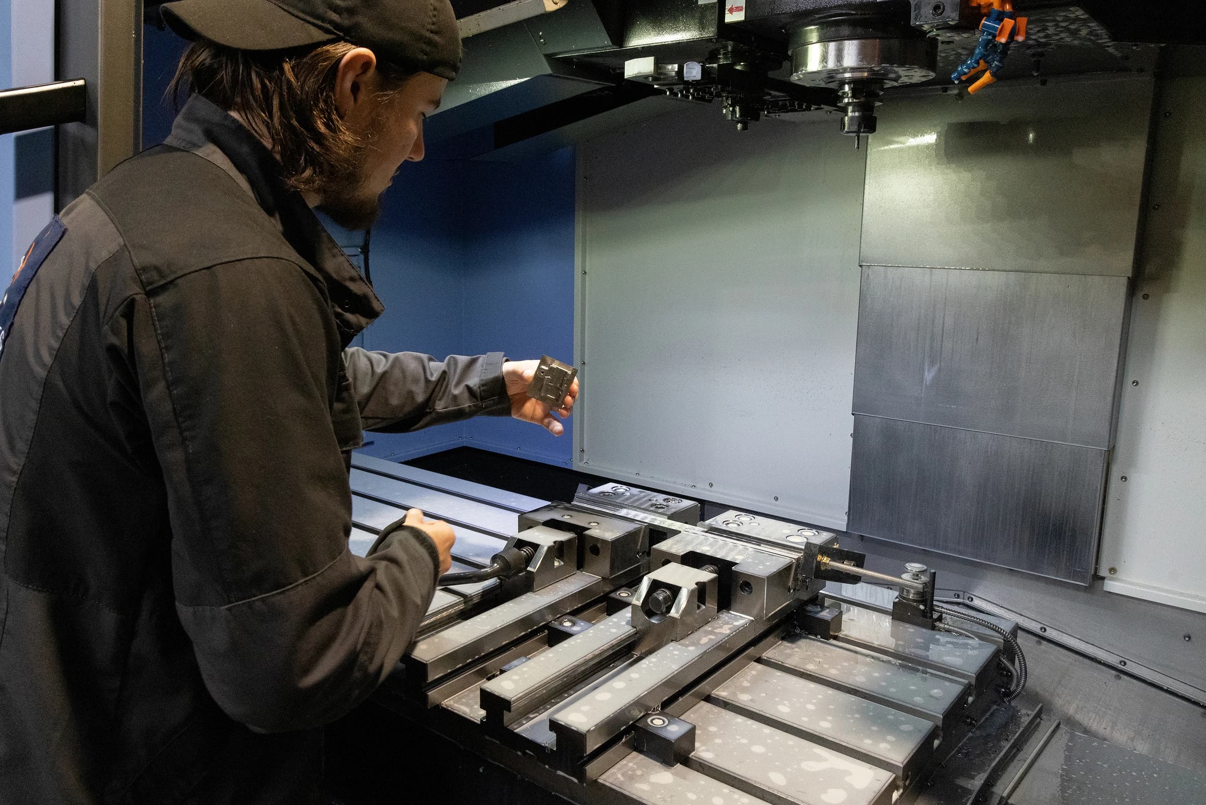 Operator at a CNC machine and workholding fixture